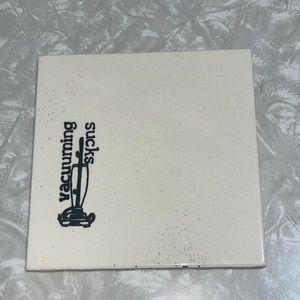 Ceramic “vacuuming sucks” tile (circa 1982)
